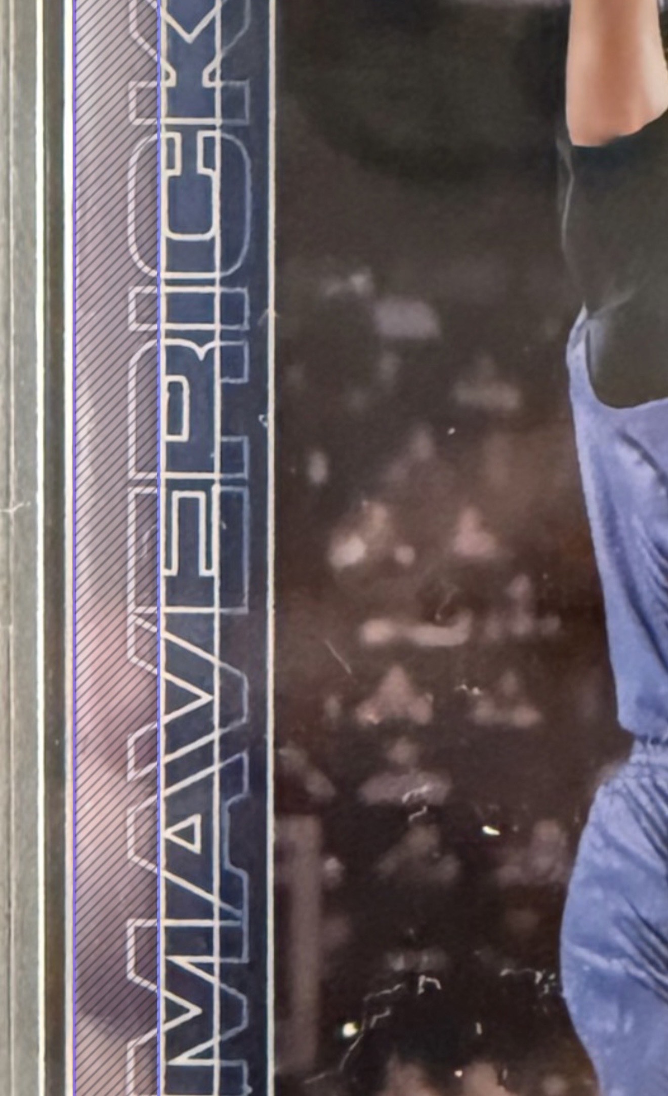 Zoomed view of the same card. A wider purple stripe marks the distance from the outer card edge to the inner chrome border frame, which cuts through the team name letters.